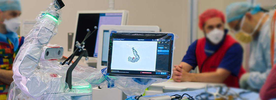 a spinal surgery robotic system with a picture of the robotic arm on a display monitor